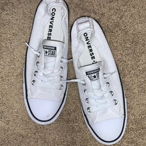 White perforated converse low.